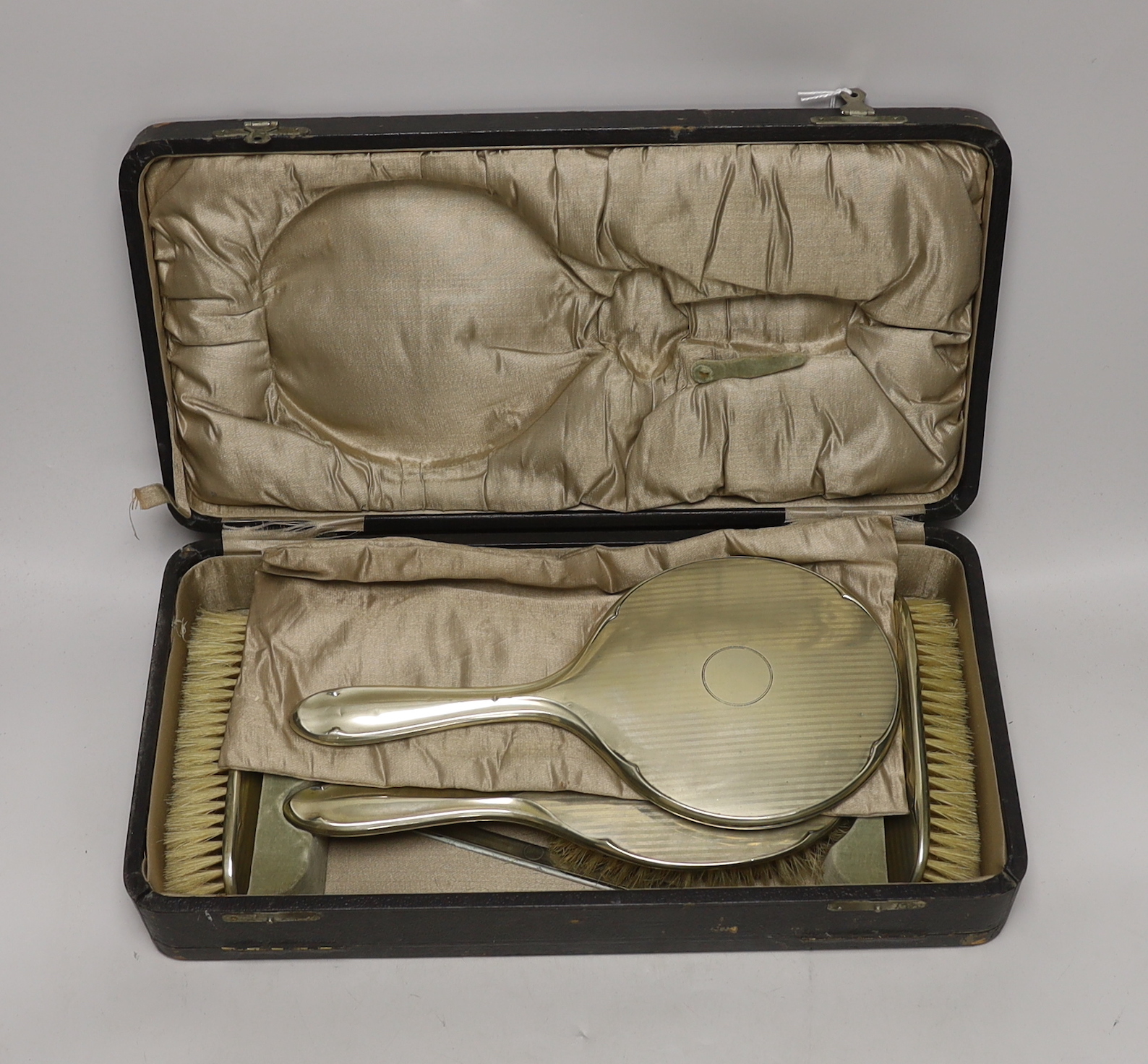 A cased 1930's six piece plated mirror and brush set.